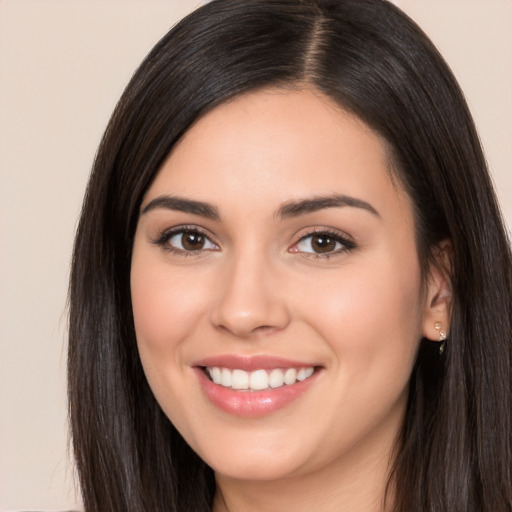 Joyful white young-adult female with long  black hair and brown eyes