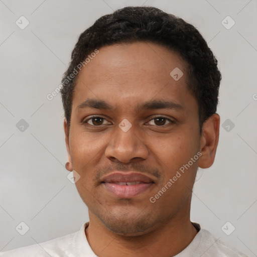 Joyful black young-adult male with short  black hair and brown eyes