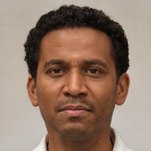 Neutral latino adult male with short  black hair and brown eyes