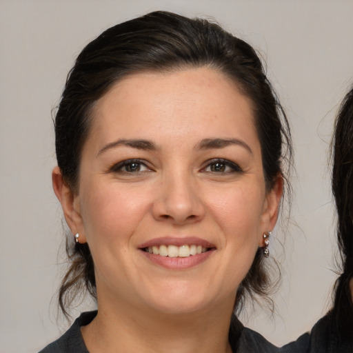 Joyful white young-adult female with medium  brown hair and brown eyes