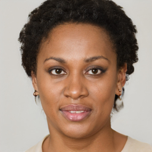 Joyful black young-adult female with short  brown hair and brown eyes