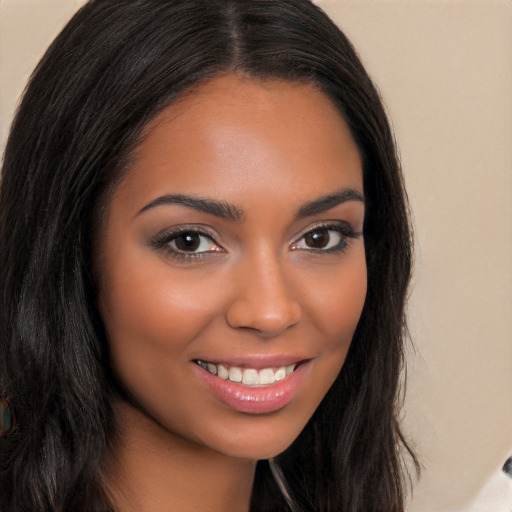 Joyful latino young-adult female with long  brown hair and brown eyes