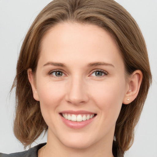 Joyful white young-adult female with long  brown hair and grey eyes