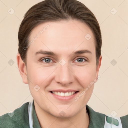 Joyful white young-adult female with short  brown hair and grey eyes