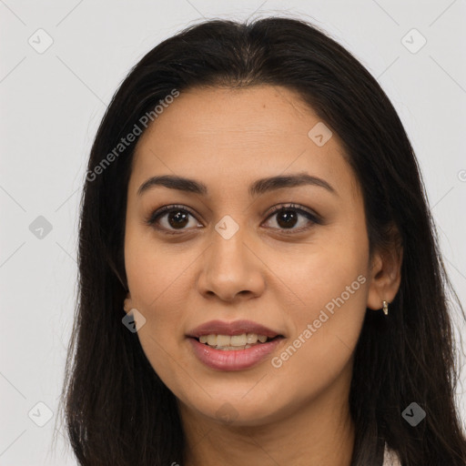 Joyful latino young-adult female with long  brown hair and brown eyes