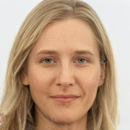 Joyful white young-adult female with long  brown hair and green eyes