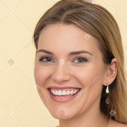 Joyful white young-adult female with long  brown hair and brown eyes