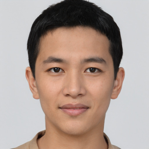 Joyful asian young-adult male with short  brown hair and brown eyes