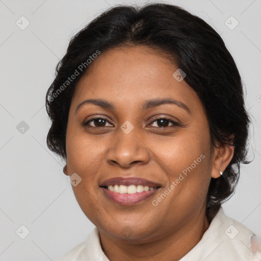 Joyful black adult female with medium  brown hair and brown eyes