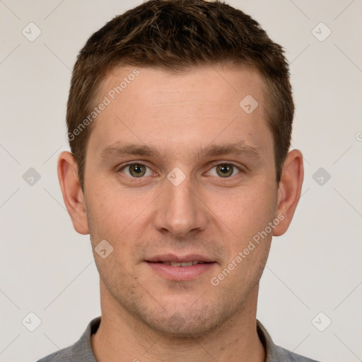 Joyful white young-adult male with short  brown hair and grey eyes