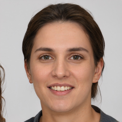 Joyful white young-adult female with medium  brown hair and brown eyes