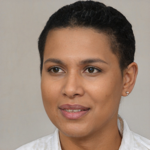 Joyful latino young-adult female with short  black hair and brown eyes