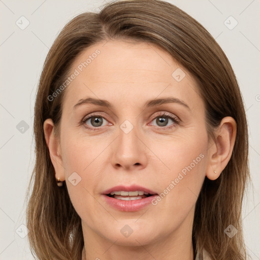 Joyful white adult female with long  brown hair and grey eyes