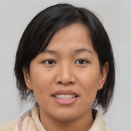 Joyful white young-adult female with medium  brown hair and brown eyes