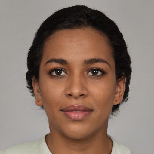 Joyful latino young-adult female with short  brown hair and brown eyes