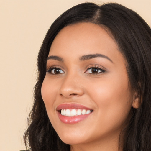 Joyful white young-adult female with long  black hair and brown eyes