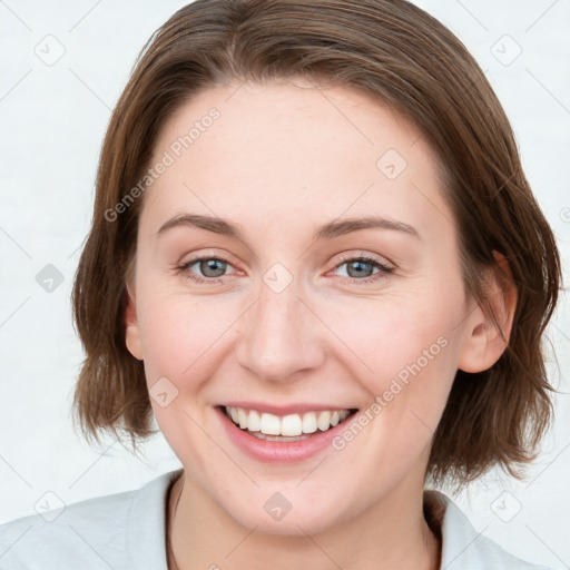 Joyful white young-adult female with medium  brown hair and blue eyes