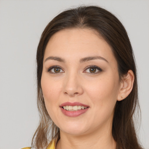 Joyful white young-adult female with long  brown hair and brown eyes