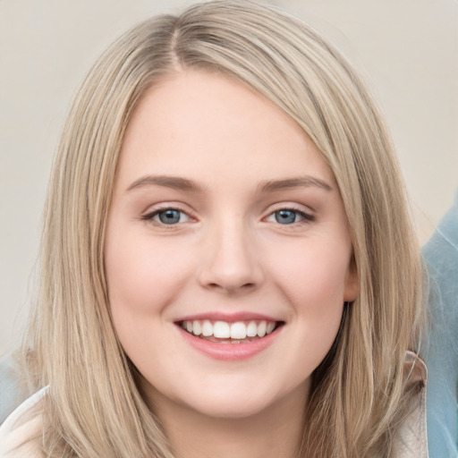 Joyful white young-adult female with long  brown hair and blue eyes