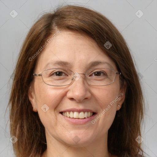 Joyful white adult female with long  brown hair and grey eyes