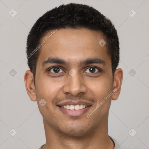 Joyful latino young-adult male with short  brown hair and brown eyes