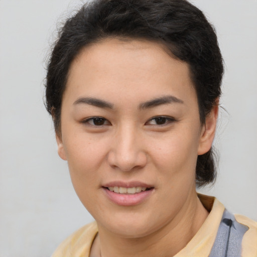 Joyful latino young-adult female with short  brown hair and brown eyes