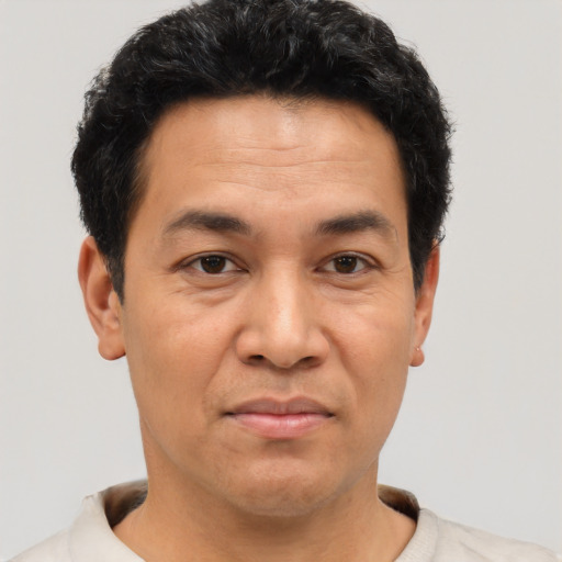 Joyful asian adult male with short  black hair and brown eyes