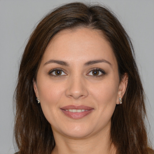 Joyful white young-adult female with long  brown hair and brown eyes