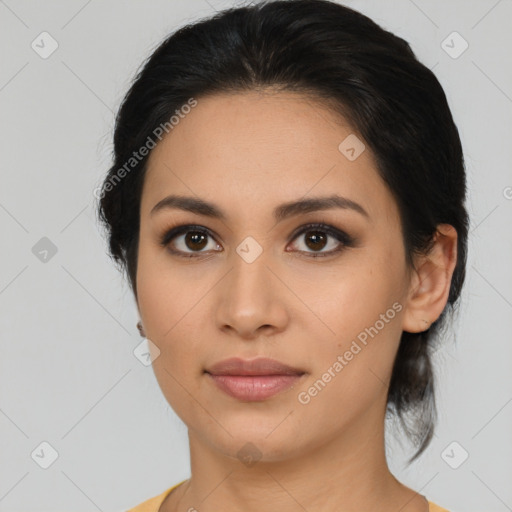 Joyful latino young-adult female with medium  brown hair and brown eyes