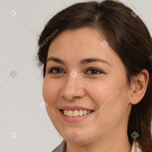 Joyful white young-adult female with medium  brown hair and brown eyes