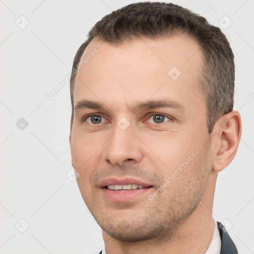 Joyful white young-adult male with short  brown hair and brown eyes