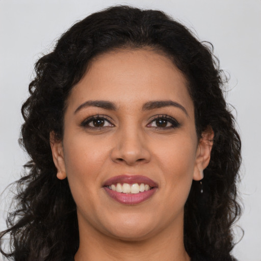 Joyful latino young-adult female with long  brown hair and brown eyes