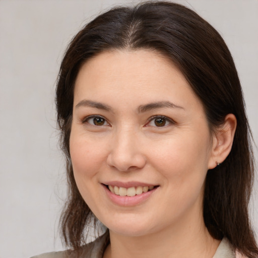 Joyful white young-adult female with medium  brown hair and brown eyes