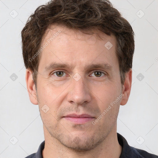 Joyful white adult male with short  brown hair and grey eyes