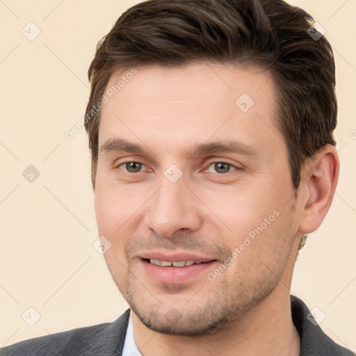 Joyful white young-adult male with short  brown hair and brown eyes