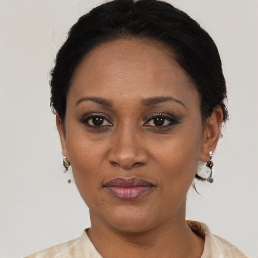 Joyful black adult female with short  black hair and brown eyes