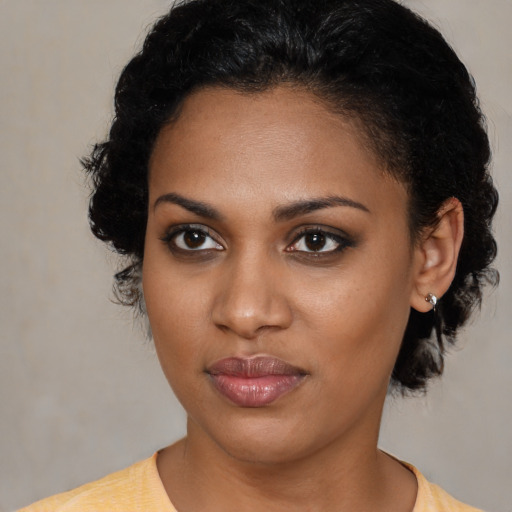 Joyful black young-adult female with short  brown hair and brown eyes