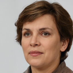 Joyful white adult female with medium  brown hair and grey eyes