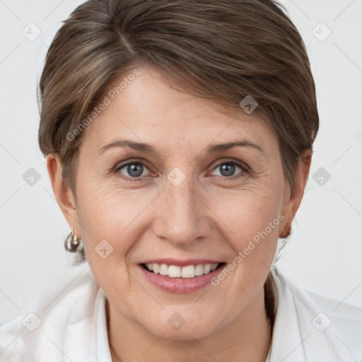 Joyful white adult female with short  brown hair and grey eyes