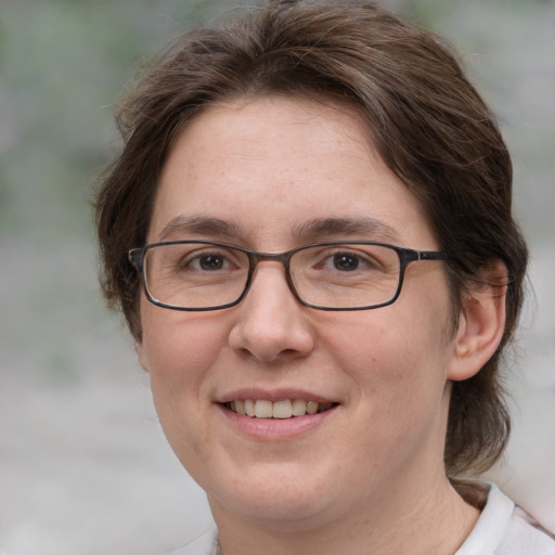 Joyful white adult female with medium  brown hair and grey eyes