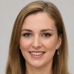 Joyful white young-adult female with long  brown hair and green eyes