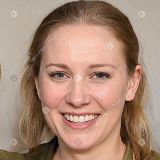 Joyful white adult female with medium  brown hair and blue eyes