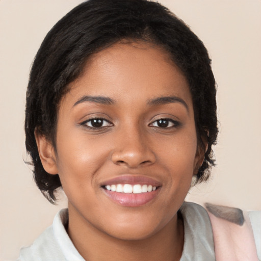 Joyful black young-adult female with medium  brown hair and brown eyes