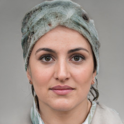 Joyful white young-adult female with medium  brown hair and grey eyes