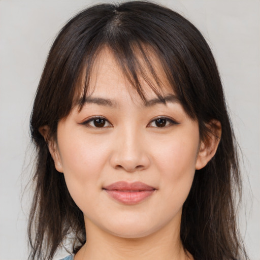 Joyful asian young-adult female with medium  brown hair and brown eyes