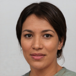 Joyful asian adult female with medium  brown hair and brown eyes