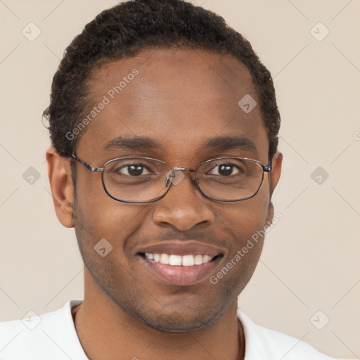 Joyful black young-adult male with short  brown hair and brown eyes