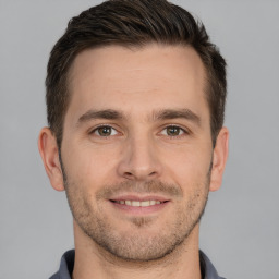 Joyful white young-adult male with short  brown hair and brown eyes