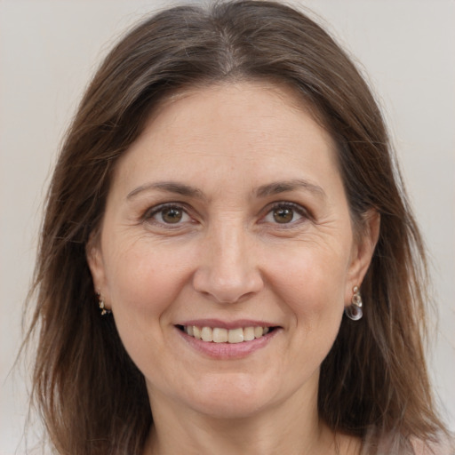 Joyful white adult female with long  brown hair and brown eyes