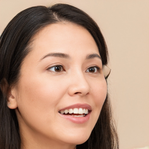 Joyful white young-adult female with long  brown hair and brown eyes